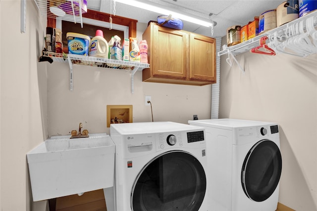 clothes washing area featuring cabinets, separate washer and dryer, and sink