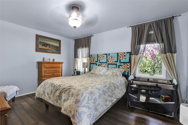 bedroom featuring dark hardwood / wood-style flooring and ceiling fan