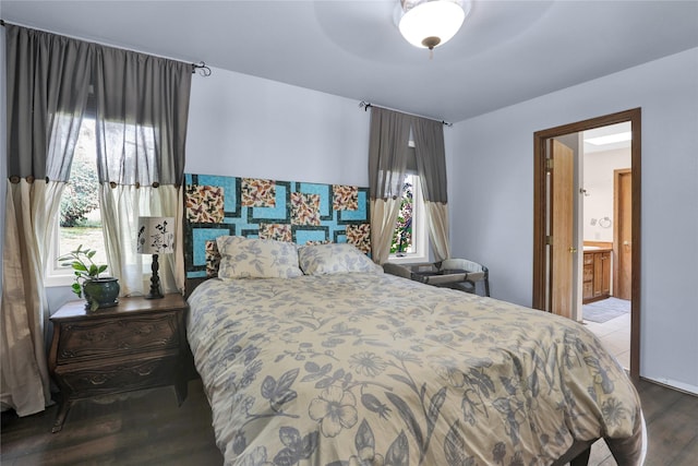 bedroom featuring wood-type flooring, ceiling fan, and ensuite bath