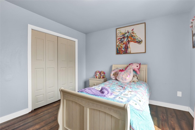 bedroom featuring dark hardwood / wood-style flooring and a closet