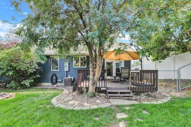 back of property featuring central AC unit, a yard, and a deck