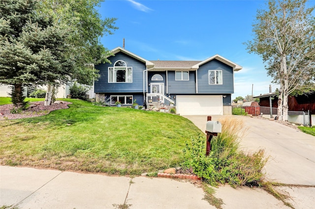 bi-level home featuring a garage and a front yard