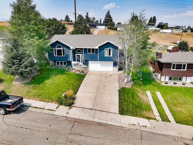 split foyer home featuring a garage and a front yard