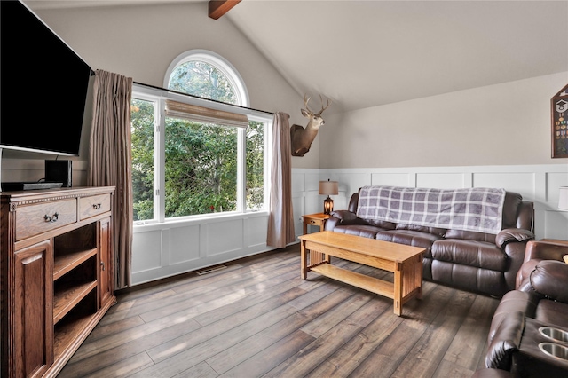 living room featuring hardwood / wood-style floors and vaulted ceiling with beams