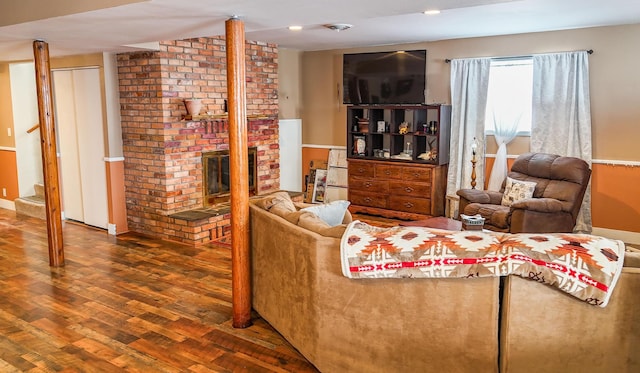 living room with a fireplace and wood-type flooring