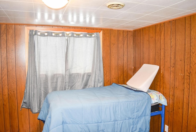 bedroom with wood walls