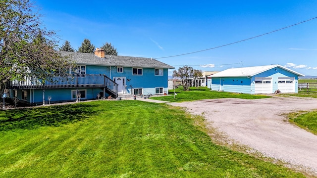 35011 Little Marten Rd, Ronan, MT 59864 - back of house featuring a chimney, stairs, a detached garage, a yard, and dirt driveway