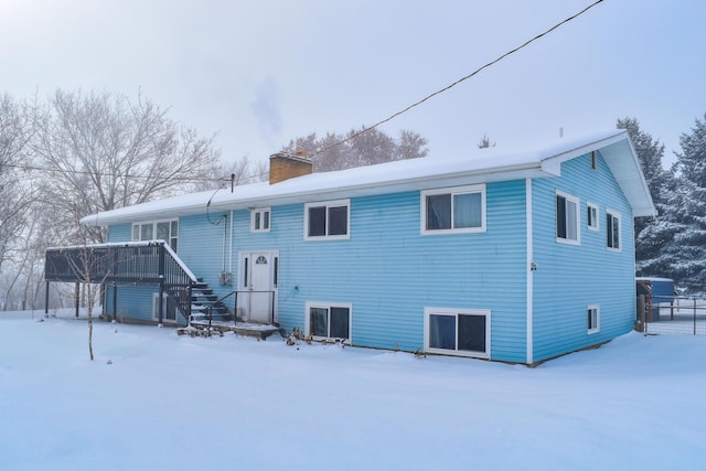 snow covered property featuring a wooden deck