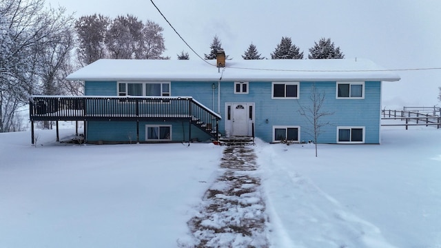 snow covered property featuring a wooden deck