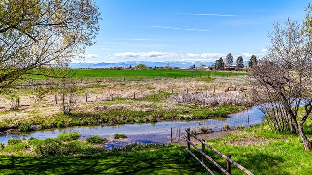 35011 Little Marten Rd, Ronan, MT 59864 - water view with mountains, rural landscape, and fence