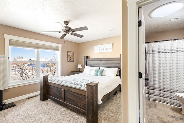 bedroom with ceiling fan and a textured ceiling