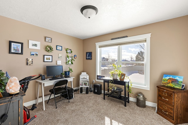 carpeted office space featuring a textured ceiling