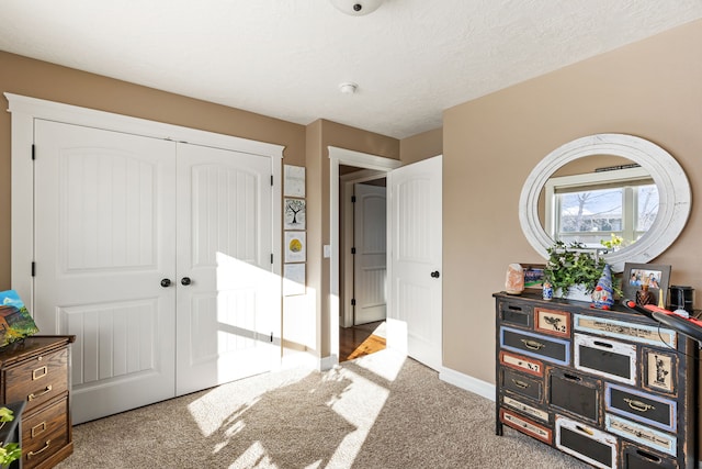 bedroom featuring a closet, a textured ceiling, and carpet