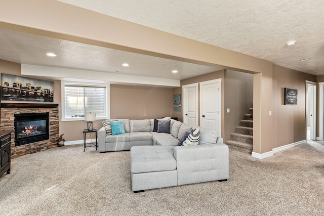 carpeted living room with a fireplace and a textured ceiling