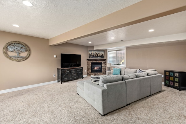 carpeted living room with beamed ceiling, a fireplace, and a textured ceiling