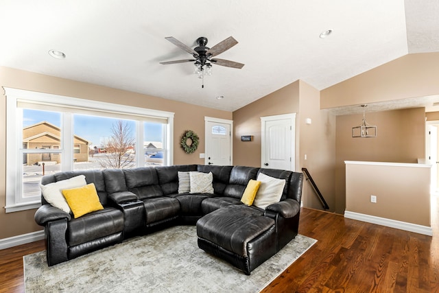 living room featuring ceiling fan, dark hardwood / wood-style flooring, and vaulted ceiling