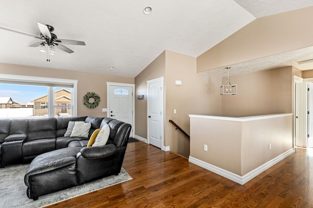 living room with dark wood-type flooring, vaulted ceiling, and ceiling fan