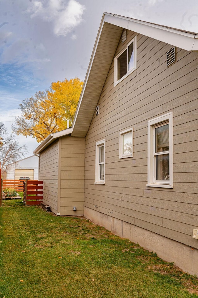 view of side of home featuring a lawn