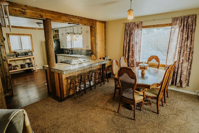 dining area featuring dark wood-type flooring