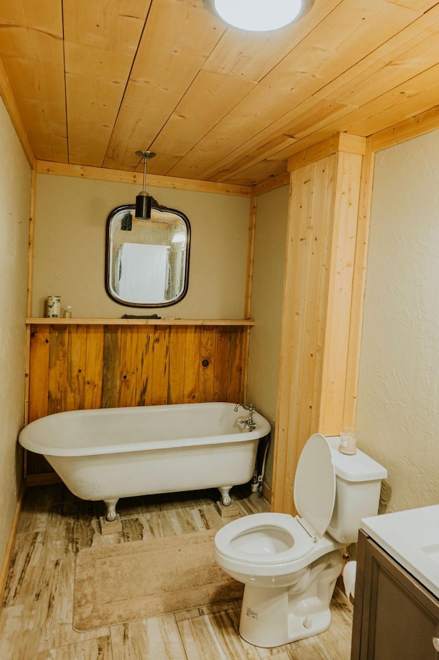 bathroom with a bathing tub, hardwood / wood-style flooring, vanity, toilet, and wooden ceiling