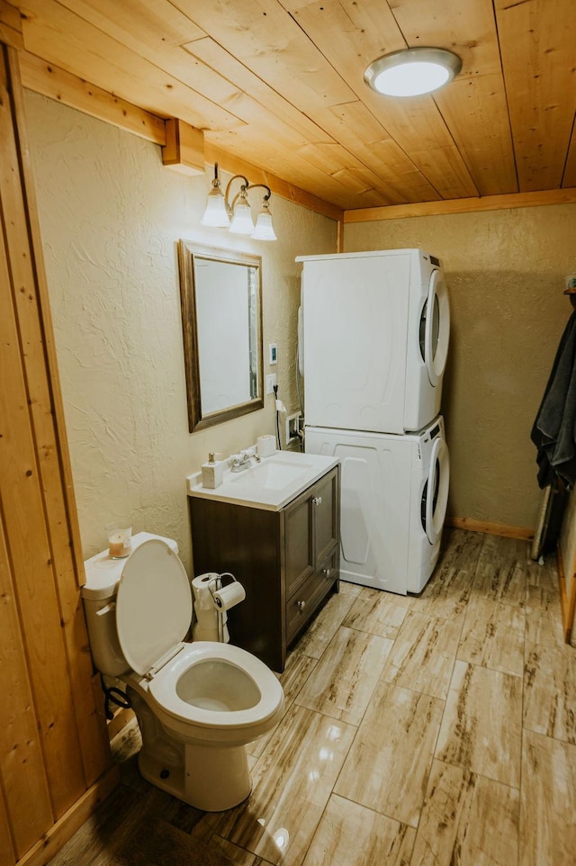 bathroom featuring stacked washer and dryer, vanity, hardwood / wood-style floors, and wood ceiling