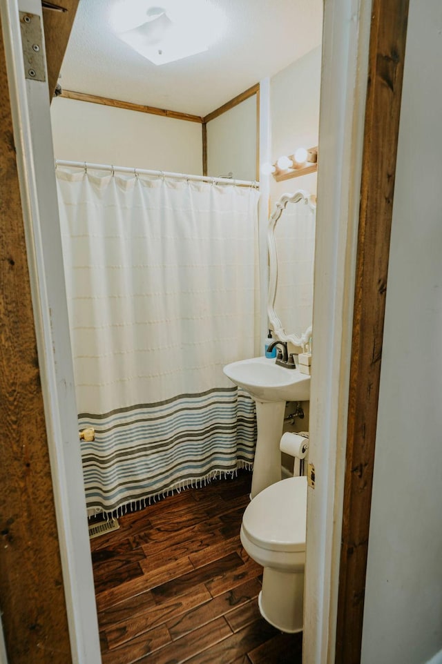 bathroom featuring toilet and hardwood / wood-style floors