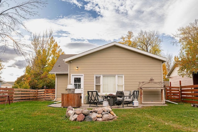 rear view of house featuring a patio area and a lawn