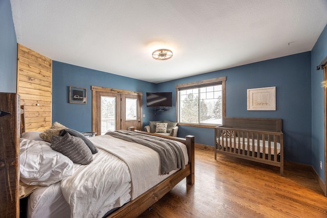 bedroom featuring hardwood / wood-style flooring and access to exterior