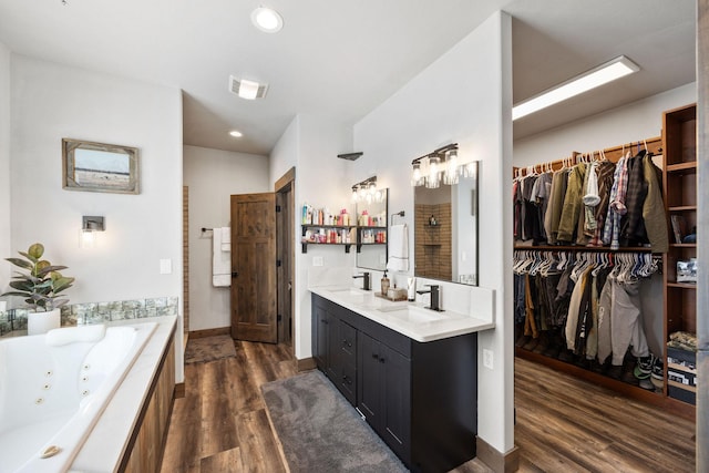 bathroom featuring vanity, shower with separate bathtub, and hardwood / wood-style floors