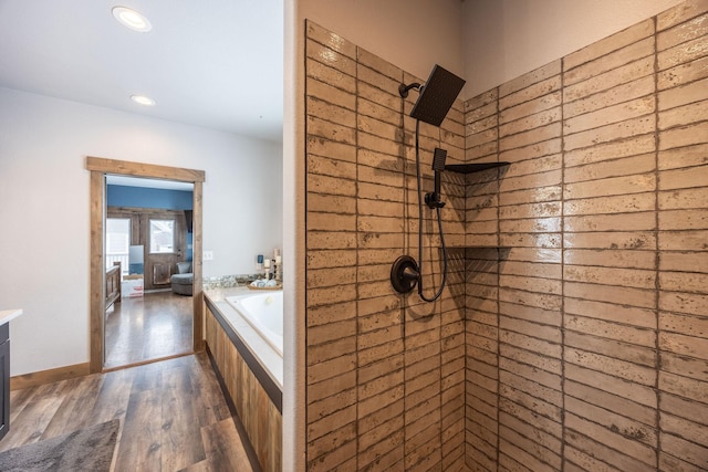 bathroom featuring hardwood / wood-style floors and separate shower and tub