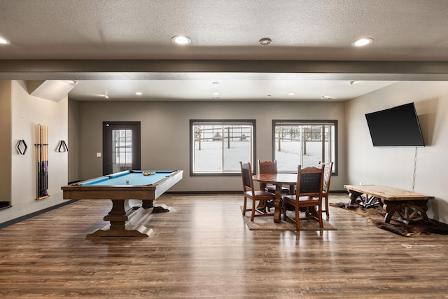 recreation room with hardwood / wood-style floors, plenty of natural light, and a textured ceiling