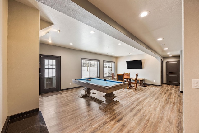 recreation room featuring a textured ceiling, light hardwood / wood-style floors, and billiards