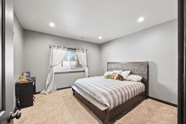 bedroom featuring light colored carpet