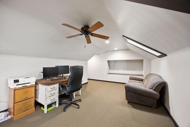 office area featuring vaulted ceiling, carpet, and ceiling fan