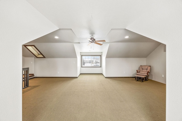 bonus room with vaulted ceiling, carpet flooring, and ceiling fan