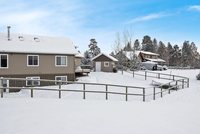 yard covered in snow with a shed