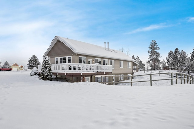 view of snow covered rear of property