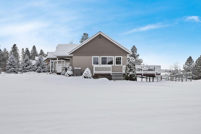 snow covered property featuring central air condition unit