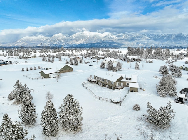 snowy aerial view featuring a mountain view