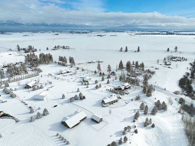 snowy aerial view featuring a rural view