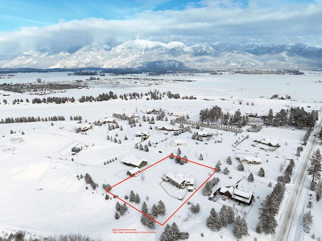 snowy aerial view with a mountain view