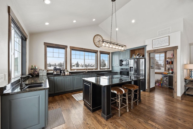 kitchen with sink, gray cabinetry, a center island, pendant lighting, and black appliances