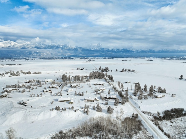 snowy aerial view with a mountain view