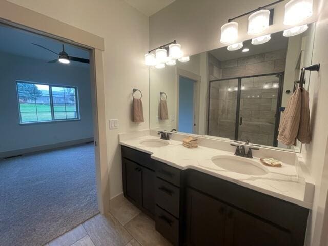 bathroom featuring vanity, an enclosed shower, and tile patterned floors