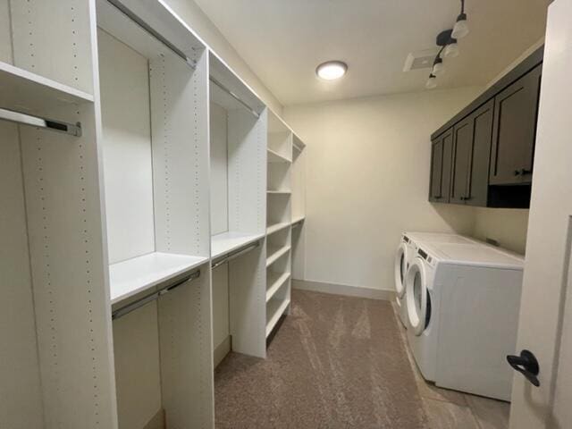 walk in closet with washing machine and dryer and carpet