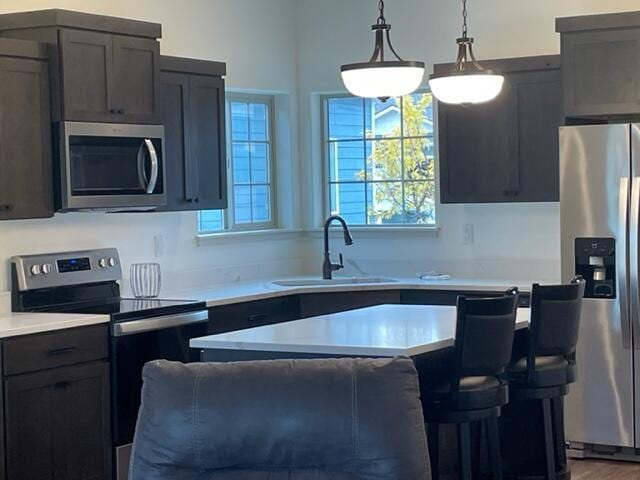 kitchen with sink, stainless steel appliances, and hanging light fixtures