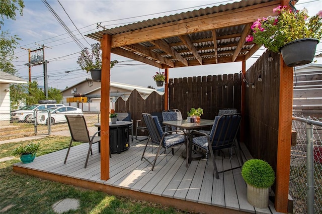 wooden terrace with fence and outdoor dining area