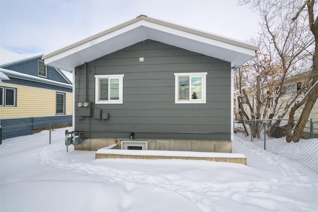 view of snow covered exterior featuring fence