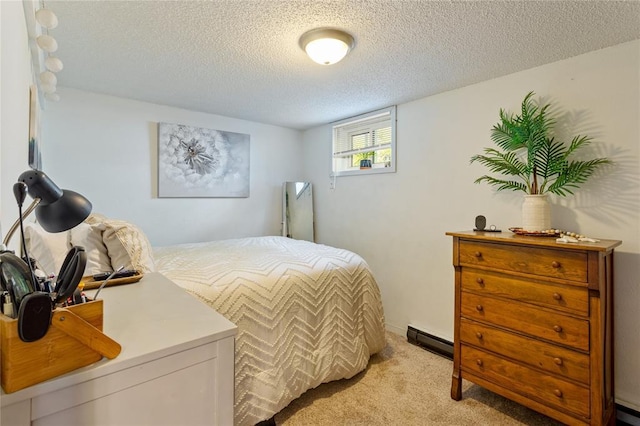 bedroom featuring a baseboard heating unit, light colored carpet, a textured ceiling, and baseboard heating