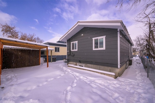 view of snow covered rear of property